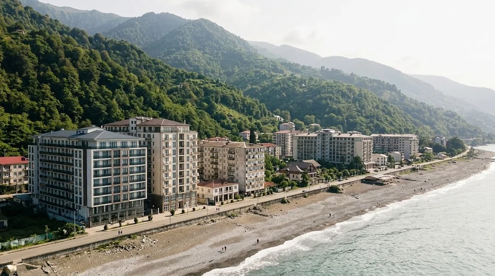 Apartment buildings between the Kvariati shoreline and green slopes
